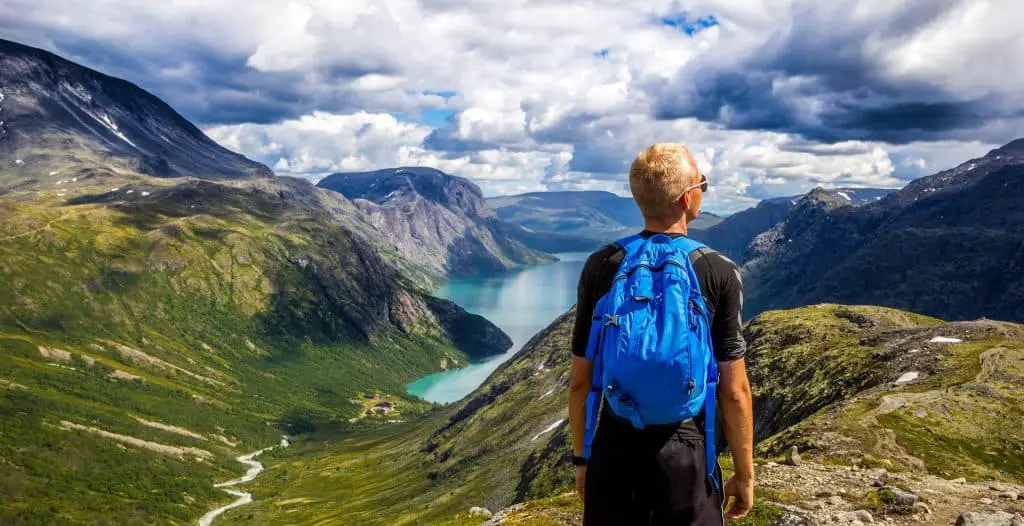 hiker wearing backpack on mountain