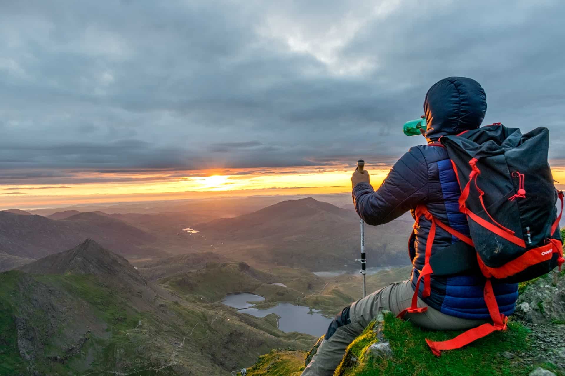 Hiker drinking water on top of mountain